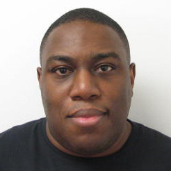 Headshot of Barry Harper looking directly at the camera while wearing a black t-shirt.