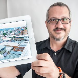 Ignacio Cardona holding an ipad with a landscape displayed on the screen 