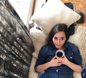 picture of Jacobé Huet from above holding a cup of coffee 