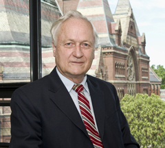 Richard T. T. Forman in black suit and red striped tie. Background red brick historical building and trees