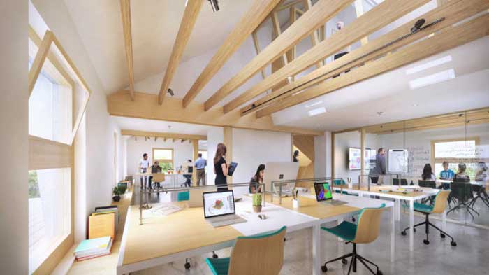 People interact with each other in a bright white workspace with wooden accents.