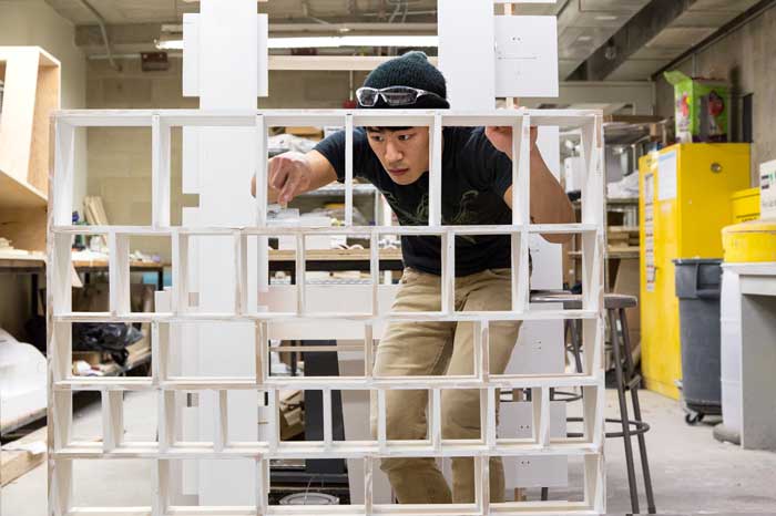 A student works on a tall project.