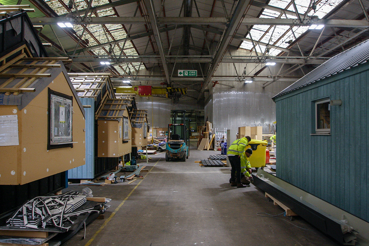 Fully assembled modular units lined up inside the factory.