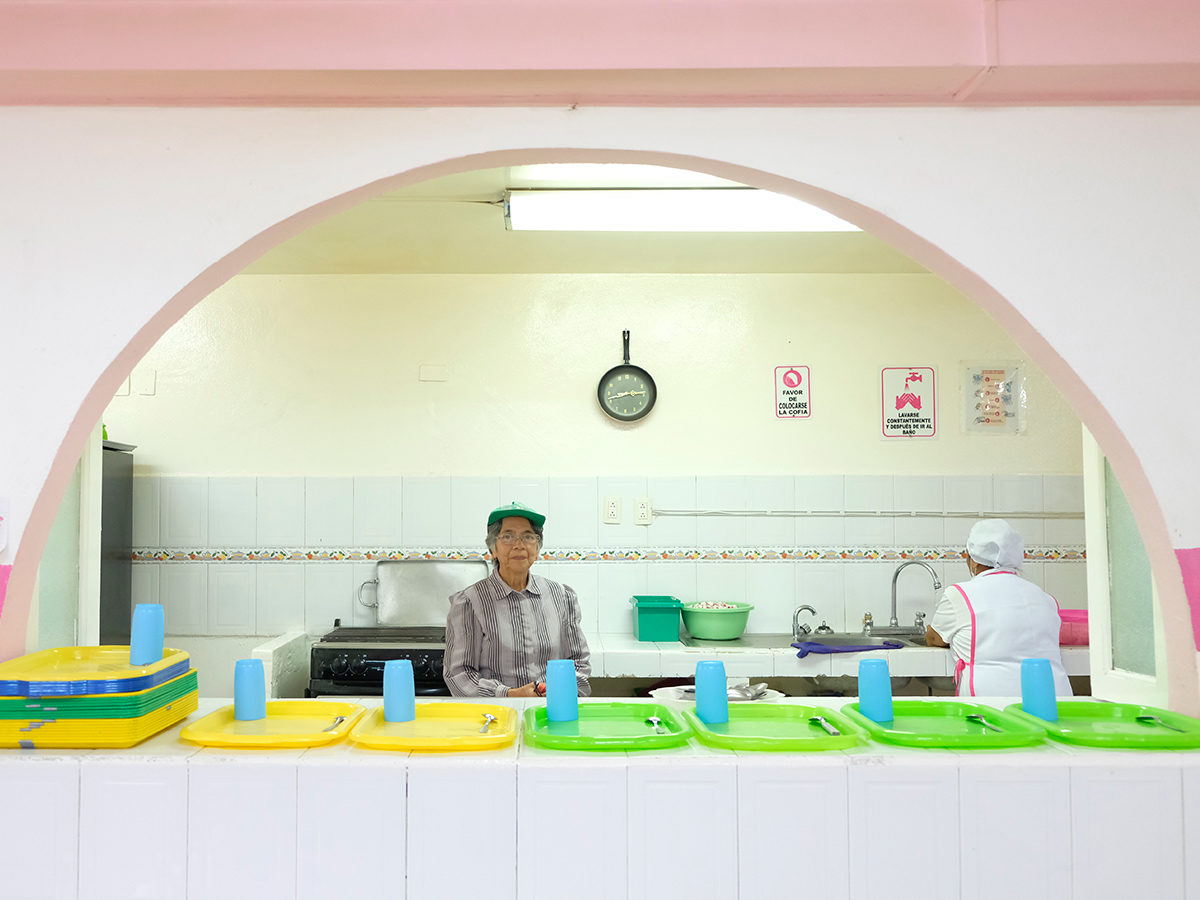 2 women standing behind a lunch counter