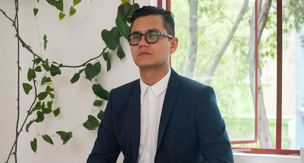 curator José Esparza sitting at a table.