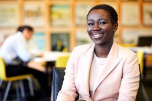 Naisha Bradley sitting and smiling towards the camera.