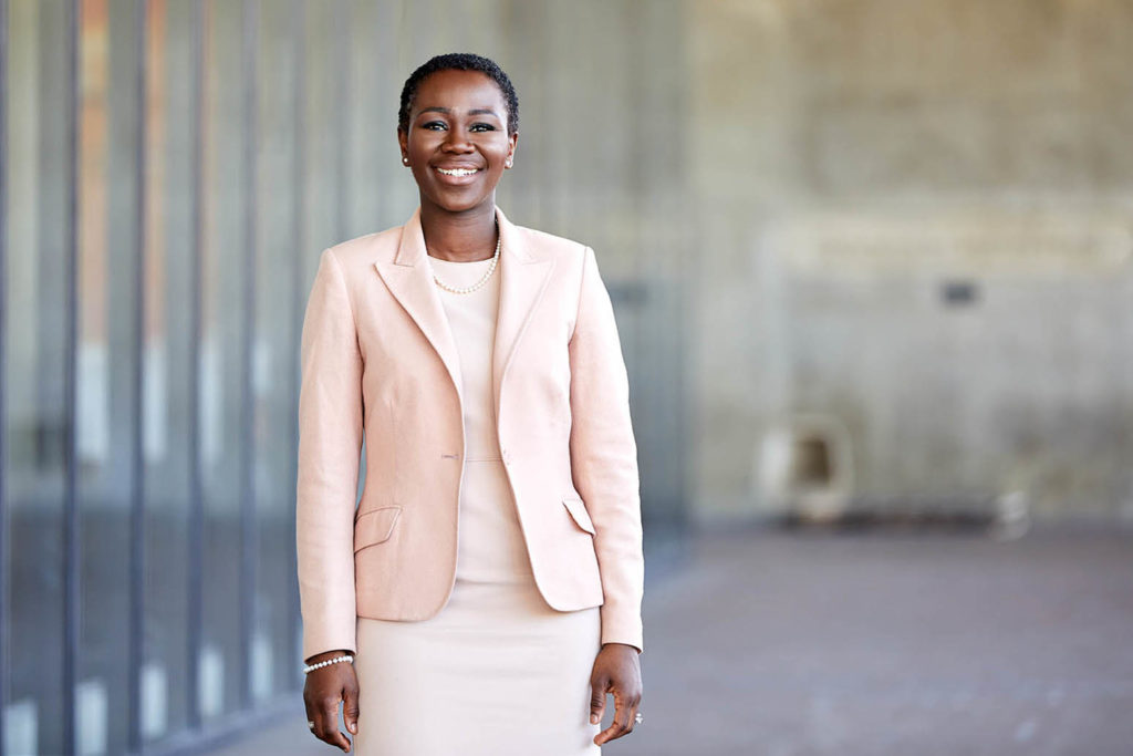 Naisha Bradley standing and smiling towards the camera.