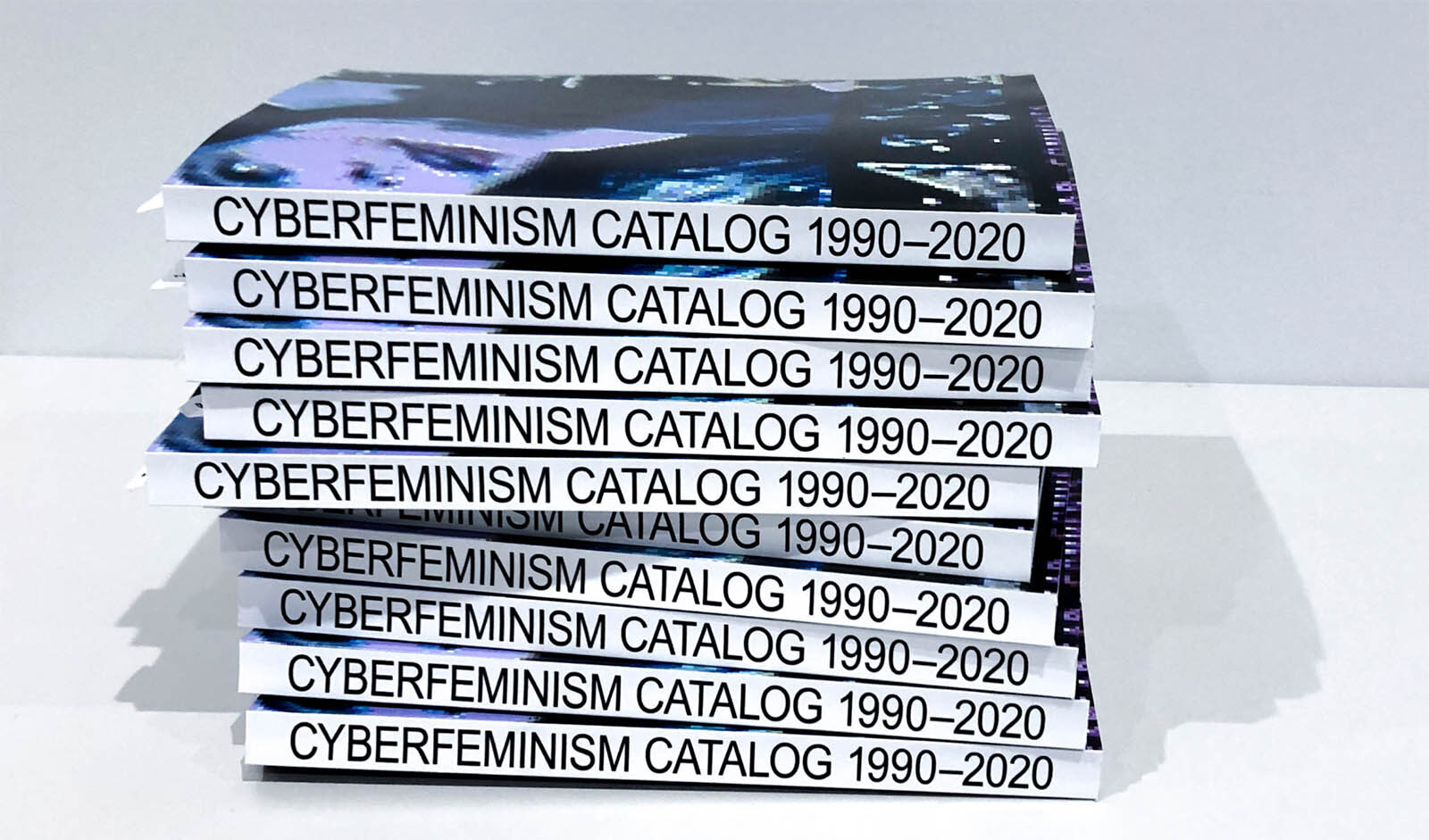stack of books on a white table labelled 