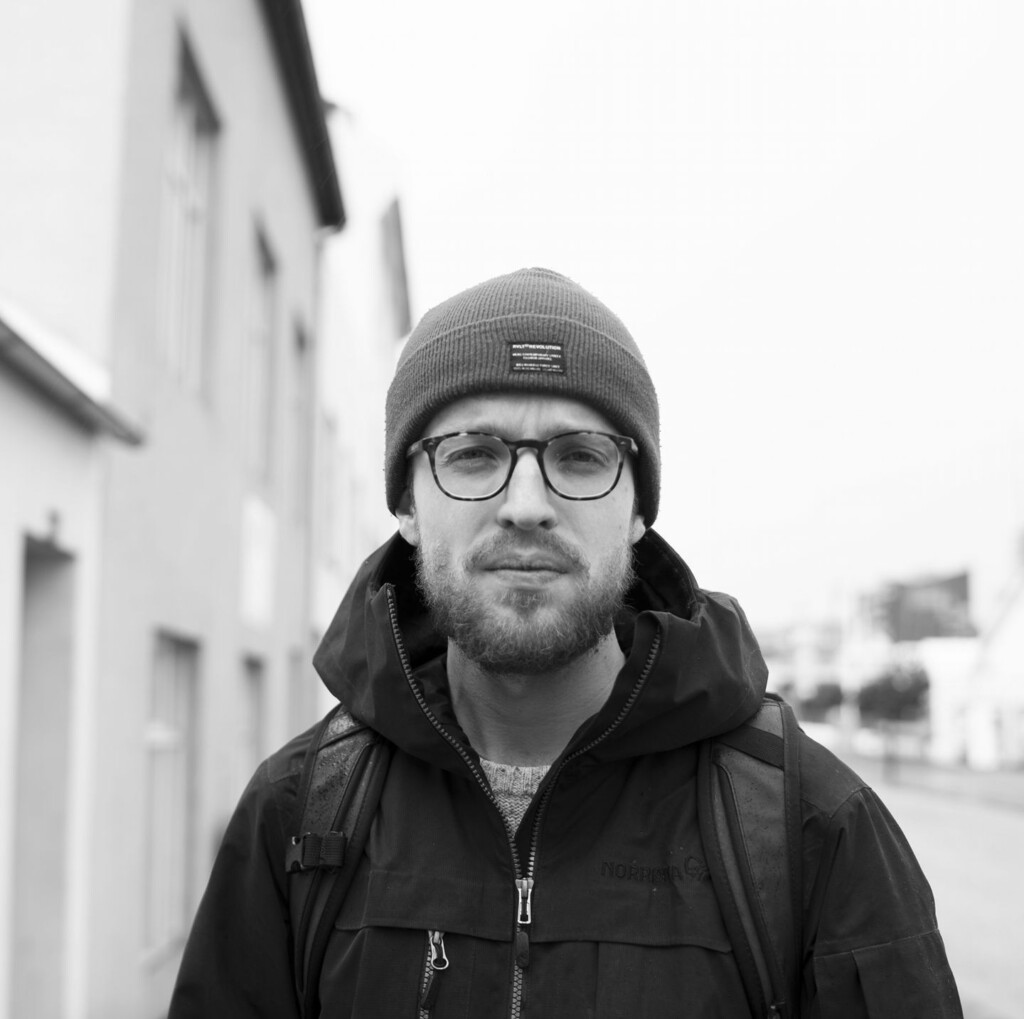 Black and white portrait of Bert wearing glasses and hat