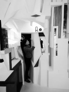 black and white picture of Rodanthi Vardouli standing in a geometric art display