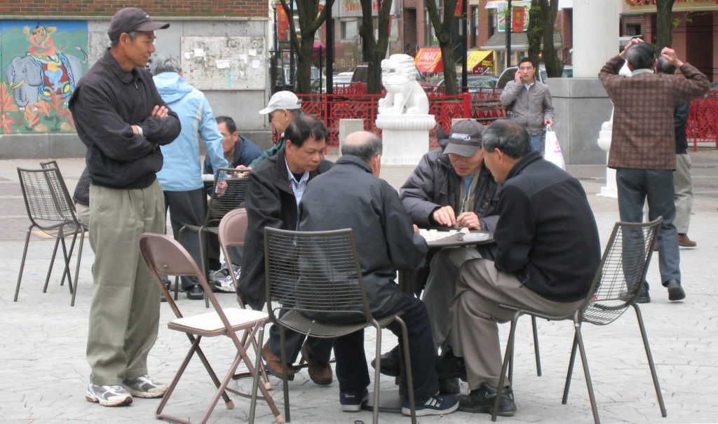 Men sitting at a table in Boston's Chinatown