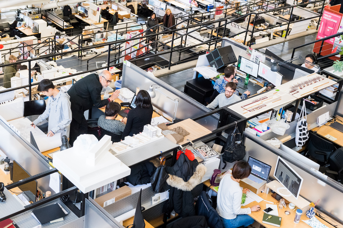 Students and faculty working at desks