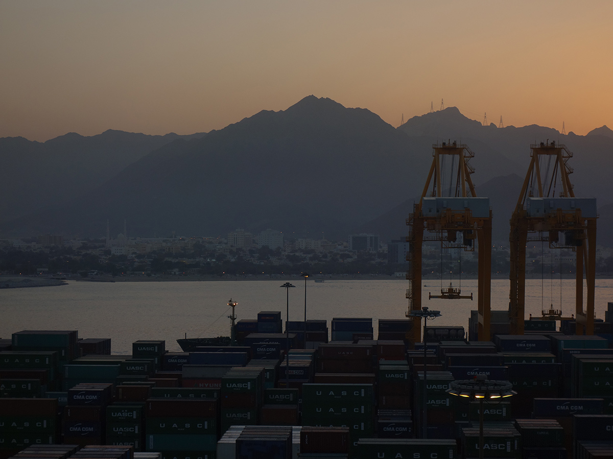 Evening skyline of shipping port with mountain background