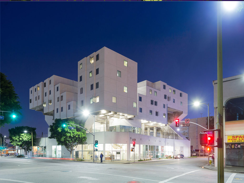 Nighttime photograph of apartment complex with streetlights