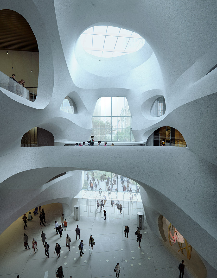 Hall with bridge and a large window. Visitors walk beneath the bridge.