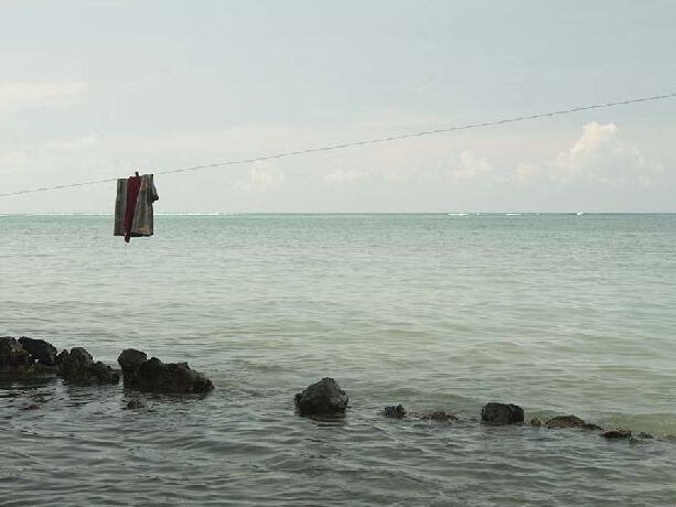 Ocean view at high tide with a clothing line