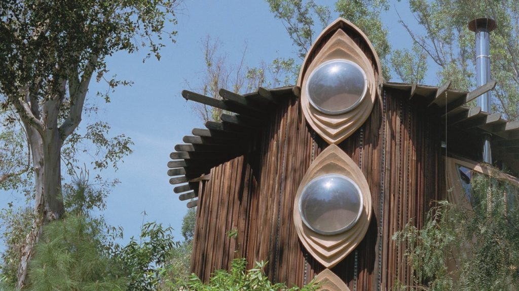 Exterior of round wooden building with round glass windows