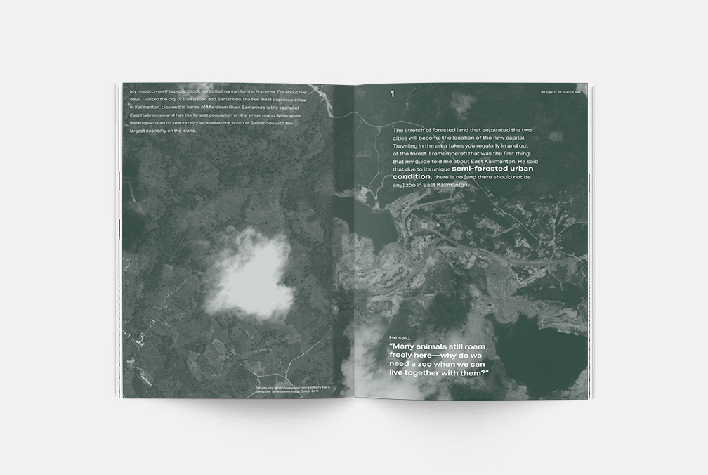 an open book depicting an aerial image of land and water