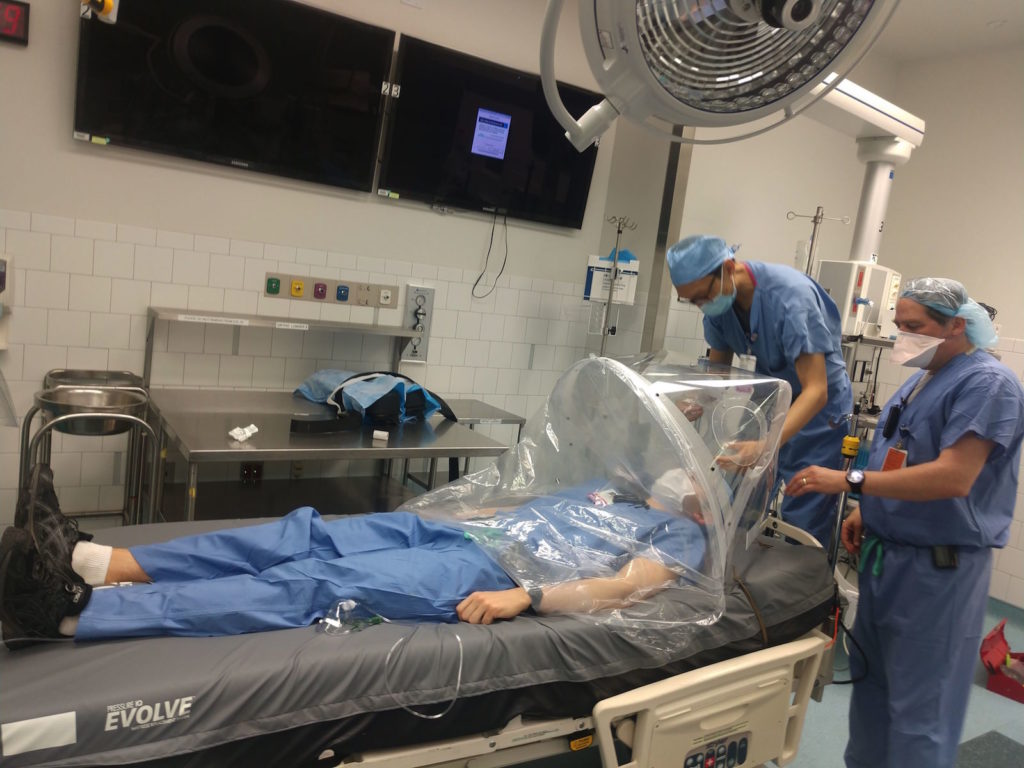 Dr. Samuel Smith (far right) and colleagues conduct clinical trials of a Harvard-developed PIH prototype