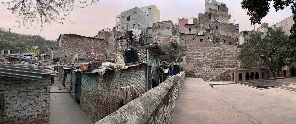 Boundary wall separating the designated monument from informal housing in Mehrauli urban village