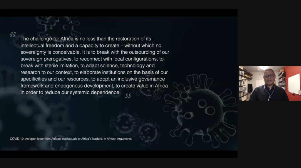 Screenshot of a presentation by Edgar Pieterse on Zoom. Pieterse is visible is on the right side of the screen. The presentation has a dark background with a faded image of microbes, with white text overlaid.
