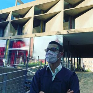Francisco Brown wearing face mask in front of modern building