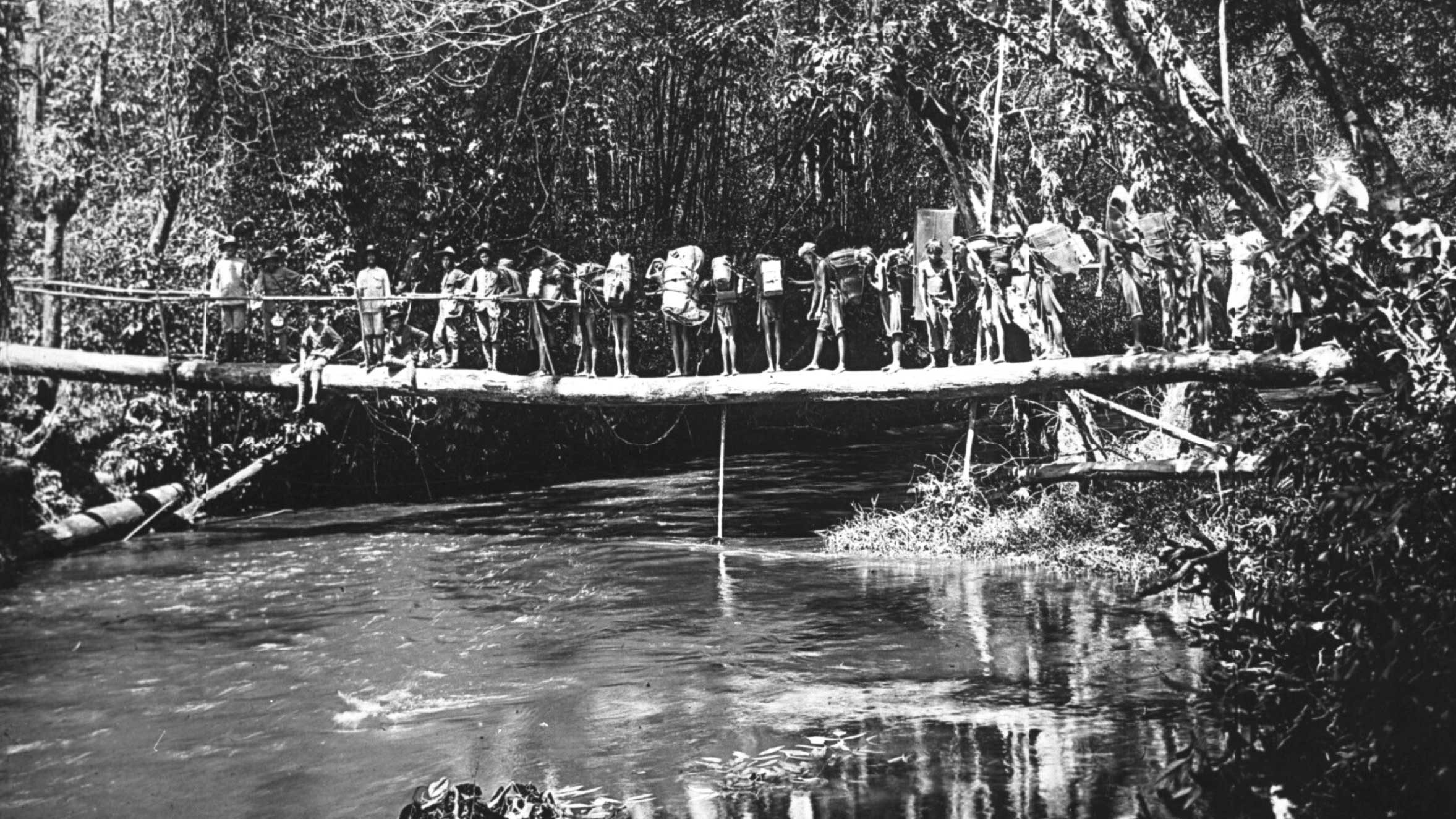 Indigenous people of Indonesia crossing a bridge