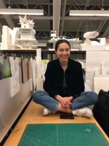 sonya sitting crosslegged on her desk