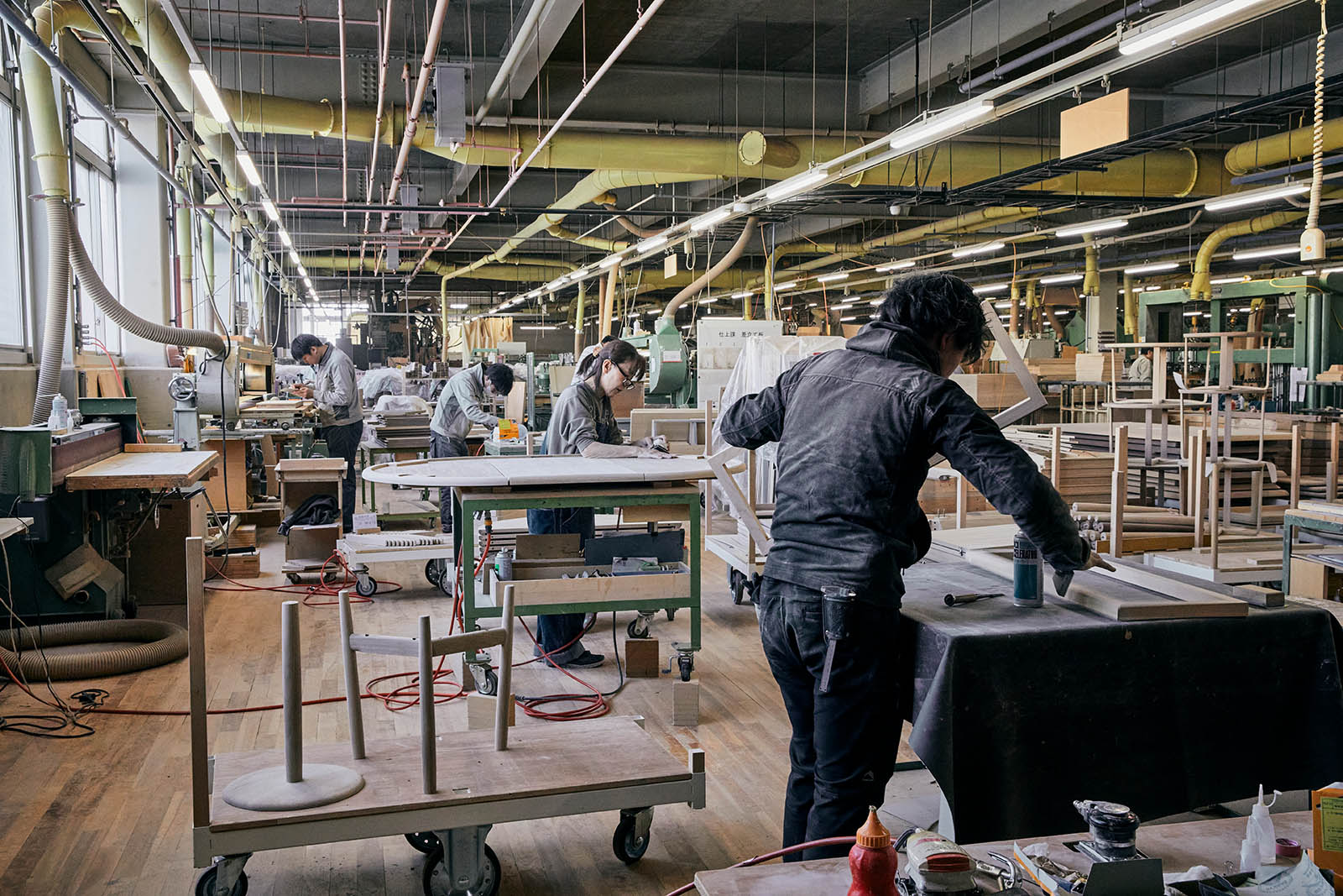 Workers in production area working with wood