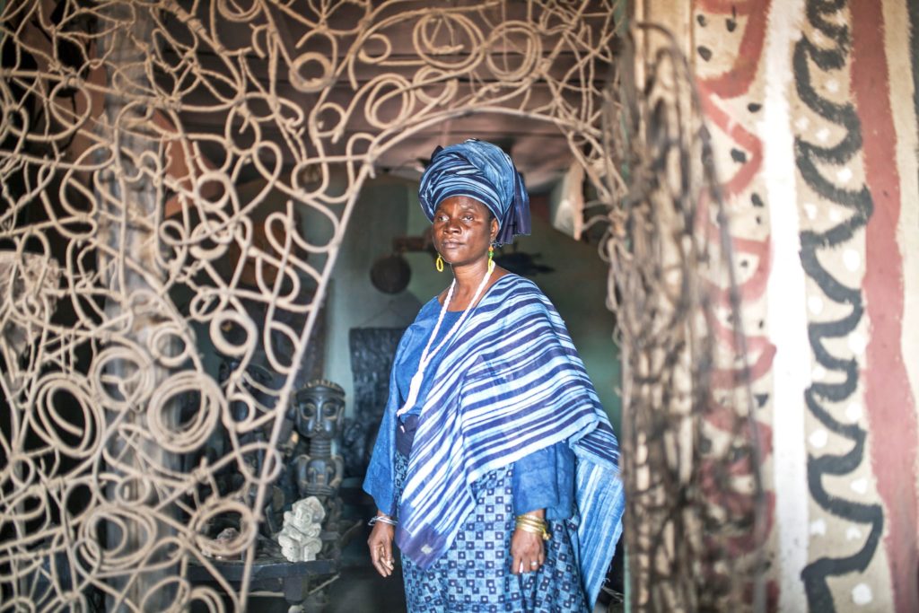 Ms. Faniyi amid carvings and décor of the New Sacred Art movement.Credit...Adolphus Opara for The New York Times
