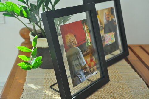 Two framed photos on a table.