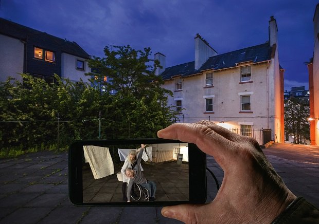 Cell phone in front of an evening scene.