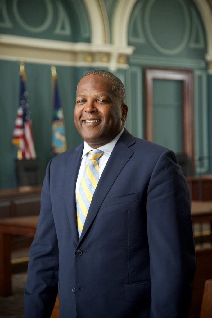 Headshot of Mayor Benjamin, who wears a suit and striped tie.