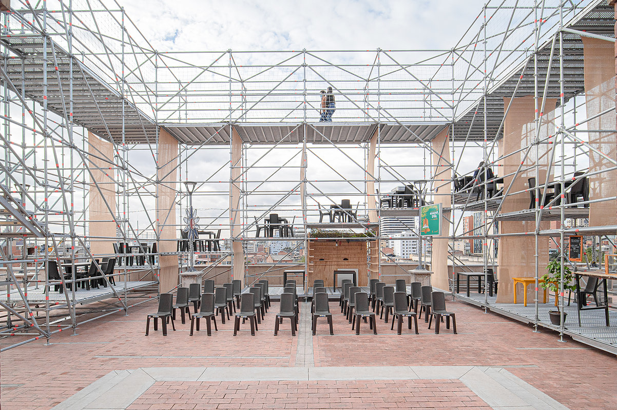 Interior image of photograph showing scaffolding structure surrounding a flat amphitheater