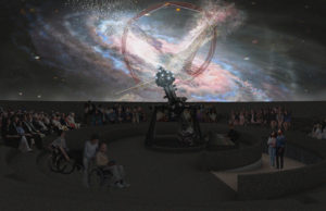 The interior dome of the cosmology center. A group of people seated in a circle watching overhead projections of constellations and other celestial bodies.