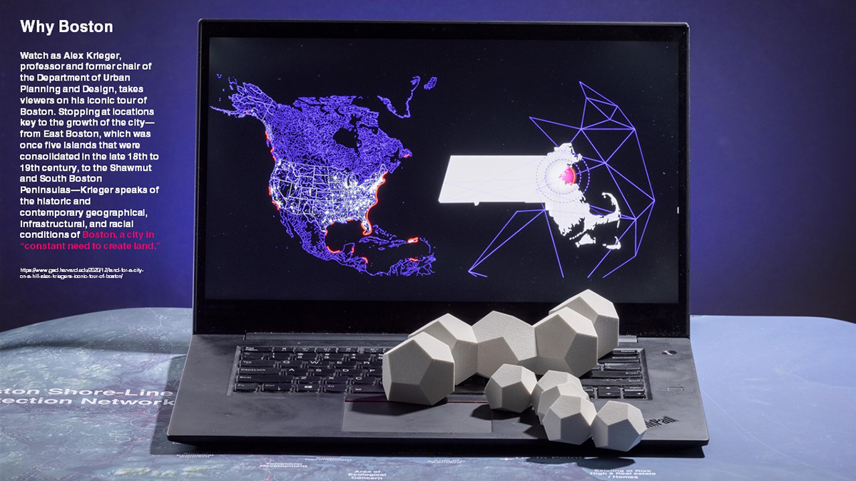 Laptop showing map of the US and Massachusetts with a model on the keyboard.