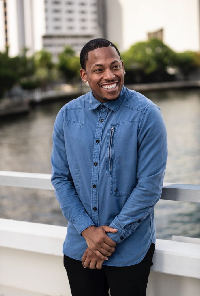 Germane Barnes smiles while standing on a bridge.