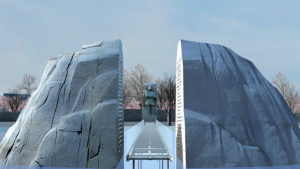 View looking towards the figure of Martin Luther King, Jr. through an opening in a large rock which has been cut into two equal halves.