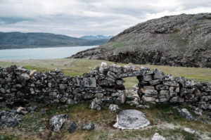 Norse ruins in landscape with lake on the background, in Greenland