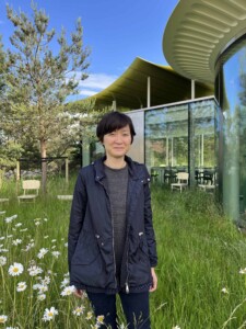 Color headshot of Angela Pang in a field of flowers