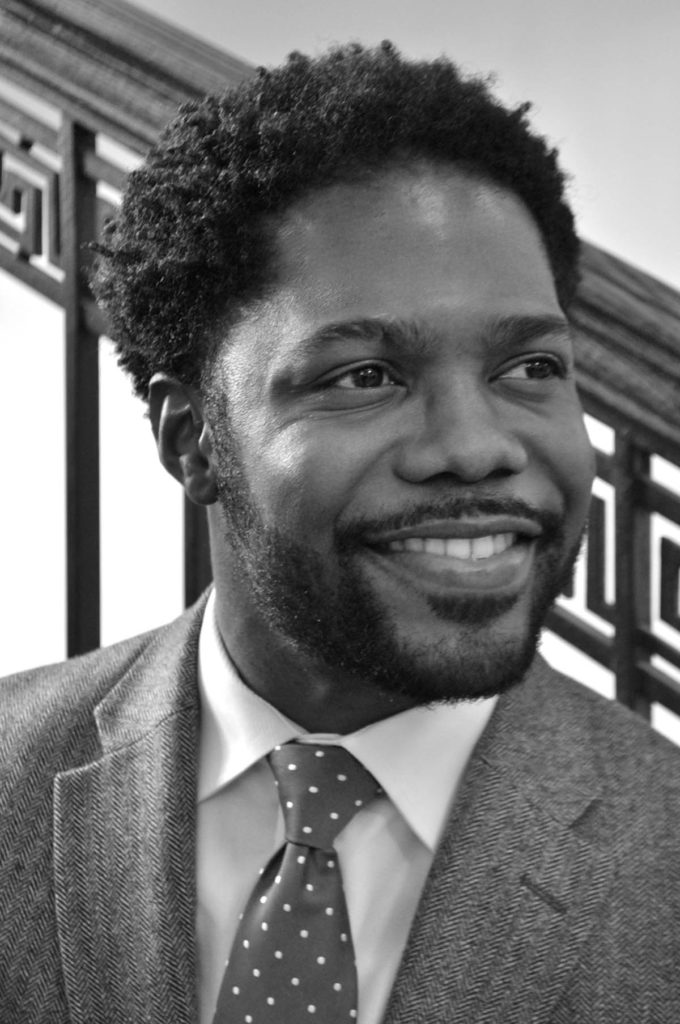 Black and white headshot of Jarvis McInnis, who wears a suit and tie.