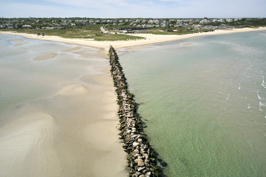 Jetty in the ocean water stemming from the coast.