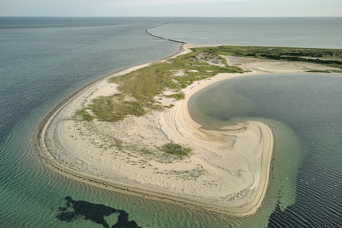 Small island with vegetation surrounded by ocean