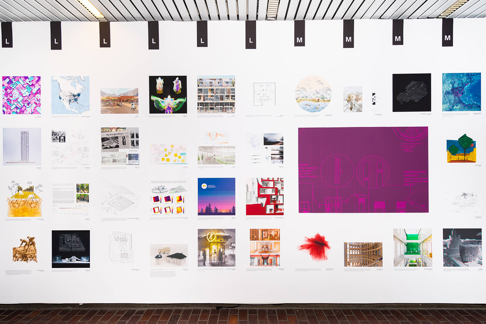 Exhibition wall with a collage of drawings.