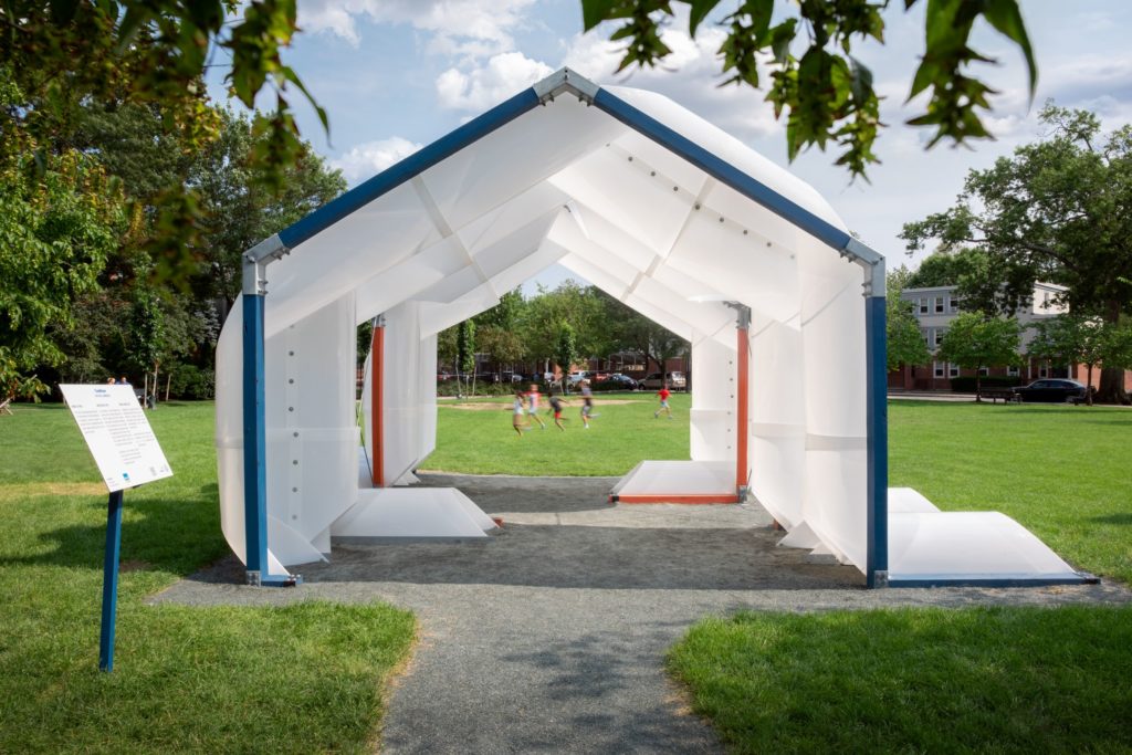 CloudHouse pavilion in a park field with children playing in the background