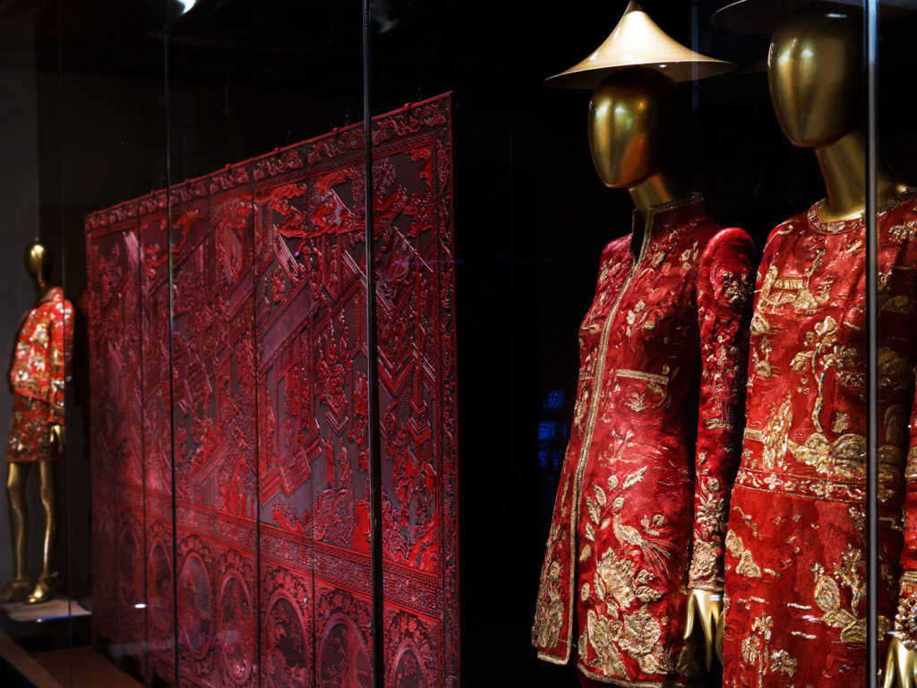 Two mannequins dressed in Asian inspired clothes in the Met exhibition China Through the Looking Glass