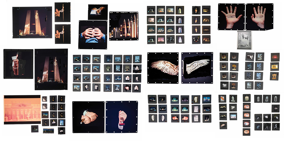 A collection of various slide photos assembled on top of a light table. The slides show varied images of monuments, buildings, hands, wings, and other items.