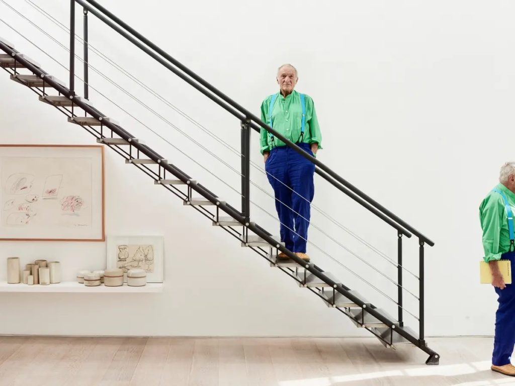 Richard Rogers standing on the stairs at home in west London.
