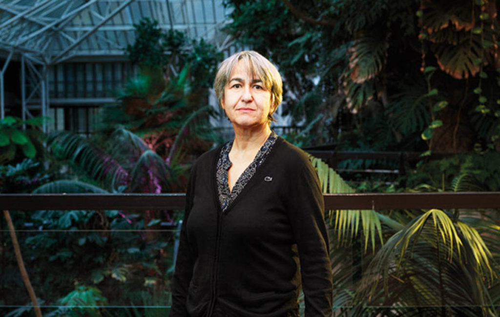 Headshot of Anne Lacaton surrounded by greenery.