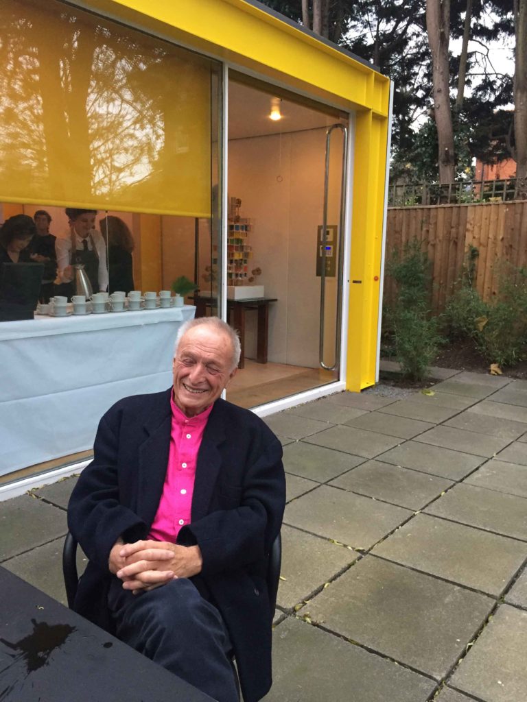 Richard Rogers wearing a florescent pink shirt, seated in front of 22 Parkside.